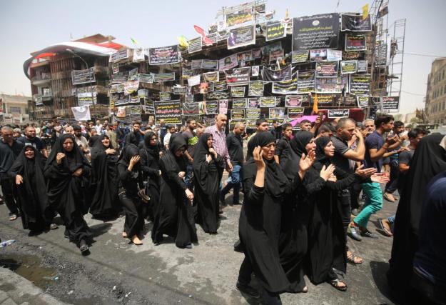 Mourners walk at the site of a suicide bombing that ripped through Baghdad's busy shopping district of Karrada on July 3, during the funeral of an Iraqi man who was killed in the attack, on July 6, 2016. The Baghdad bombing claimed by the Islamic State group killed at least 250 people, officials said on July 6, raising the toll of what was already one of the deadliest attacks in Iraq. / AFP PHOTO / Ahmad al-RubayeAHMAD AL-RUBAYE/AFP/Getty Images